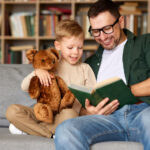 dad reading to son on couch