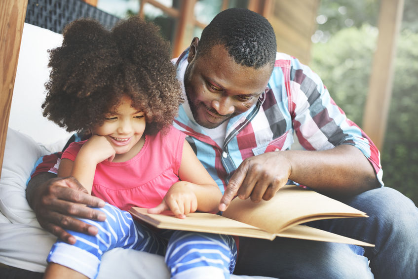 Father and daughter reading book