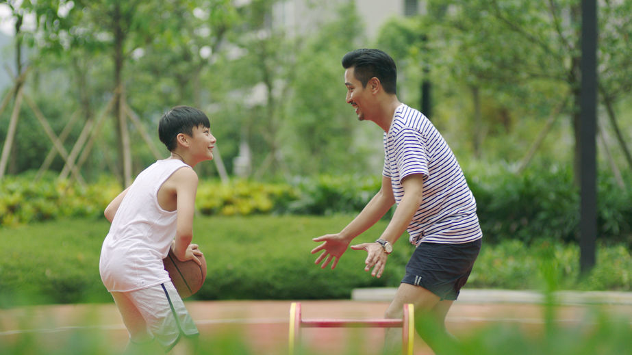 father and son playing basketball