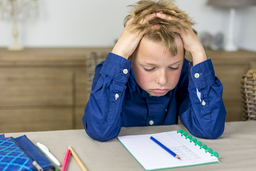 boy struggling with homework